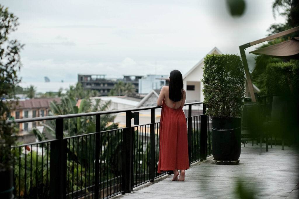 A woman standing on a balcony a stylish hotel in Ao Nang Krabi